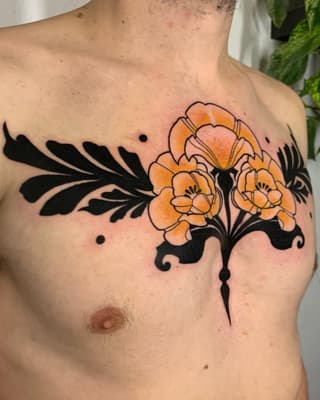 Chest tattoo featuring orange flowers with black ornamental leaf designs and decorative flourishes on male torso.