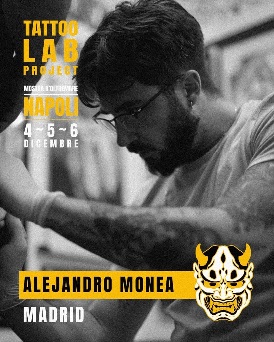 Tattoo artist Alejandro Monea from Madrid applies a yellow and white horned demon mask design on a client's arm during the Tattoo Lab Project exhibition in Naples, December 4-6.