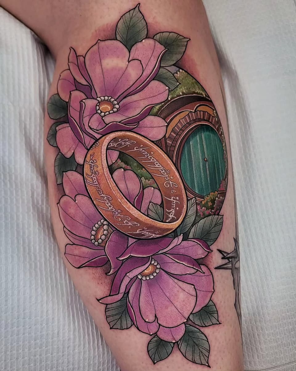 Pink flowers with green leaves frame a gold ring and green door on the inner arm, adorned with pearl details and engraved text.