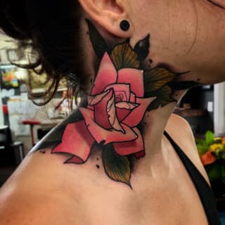 Red rose with black outline and green-brown leaves on a person's neck and shoulder area.