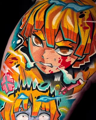 Colorful shoulder tattoo featuring an anime-style character with orange hair, large expressive eyes, and layered clothing in vibrant yellows, oranges, teals, and reds.