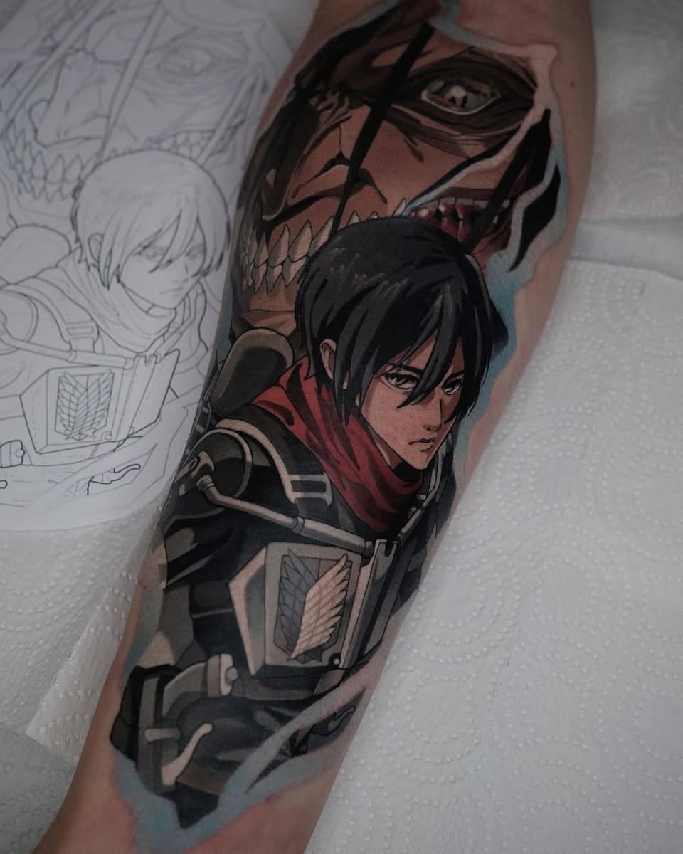 Colored tattoo on upper arm featuring two anime characters in dark clothing with detailed facial features and armor elements, displayed next to sketch designs.