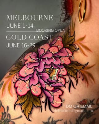 Vibrant pink and gold peony flower tattoo on shoulder with black outlines and small insect detail, displayed on person's neck and upper body.