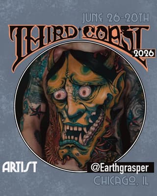 Gold and teal skull with red eyes and ornamental details tattooed on chest and shoulder, featuring complementary designs on surrounding skin.
