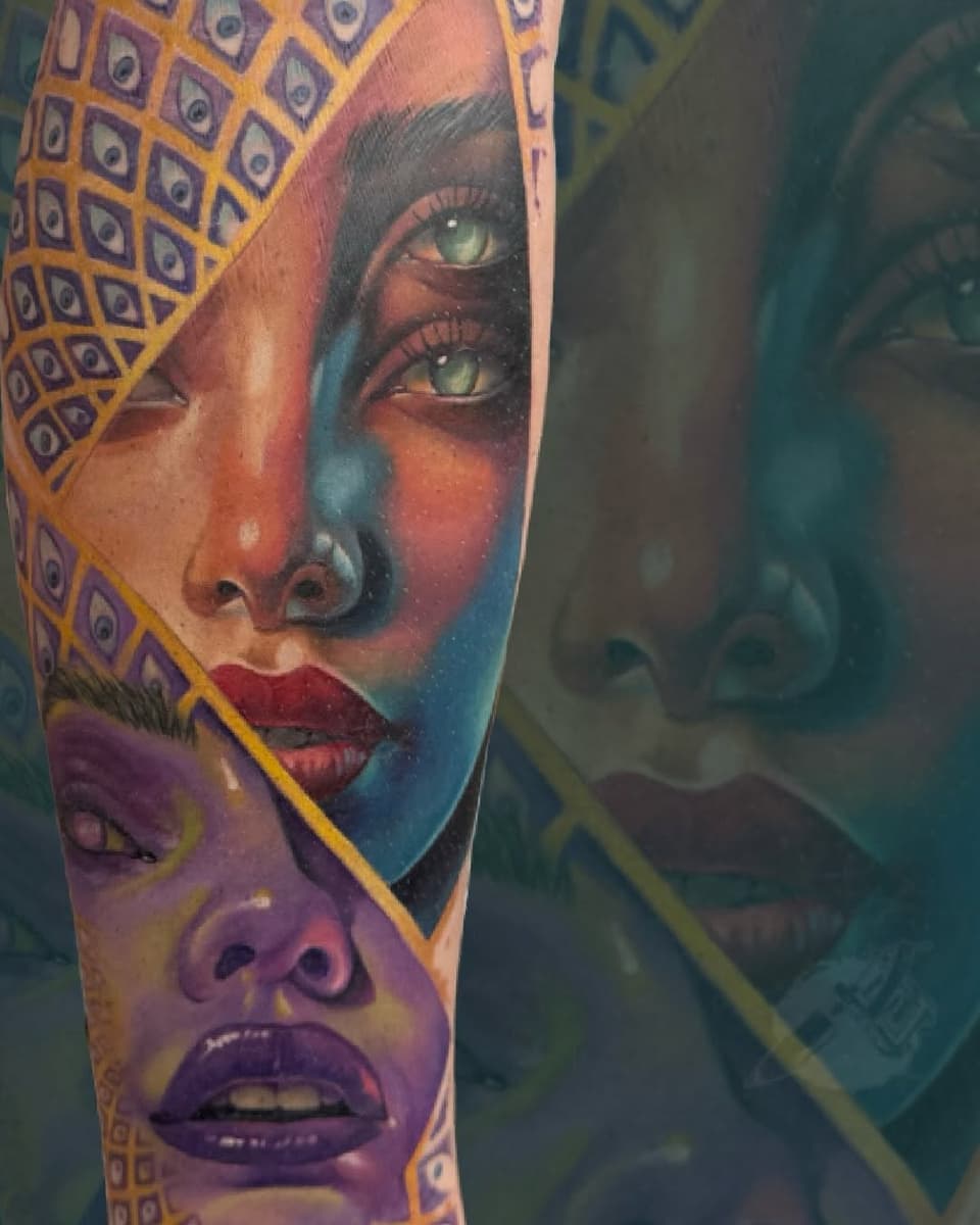 Colorful portrait tattoo on arm featuring a woman's face with striking green eyes, geometric patterned headwrap in gold and purple, vibrant gradient background.