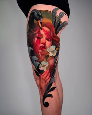 Colorful leg tattoo featuring a red-haired woman's face with black birds, white flowers, and decorative black scrollwork elements.