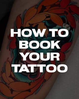 Colorful floral tattoo featuring red and orange flowers with teal leaves and black outlines on the upper arm.