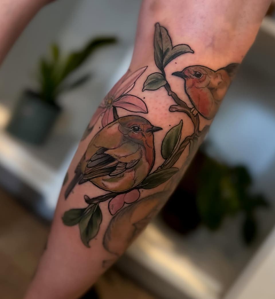 Two brown birds perched on pink flowers with green leaves on an arm, colored in warm earth tones and soft pastels.
