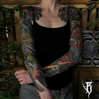 Full-sleeve colorful tattoos featuring flowers, mythical creatures, and ornamental designs on both arms with dark background elements.