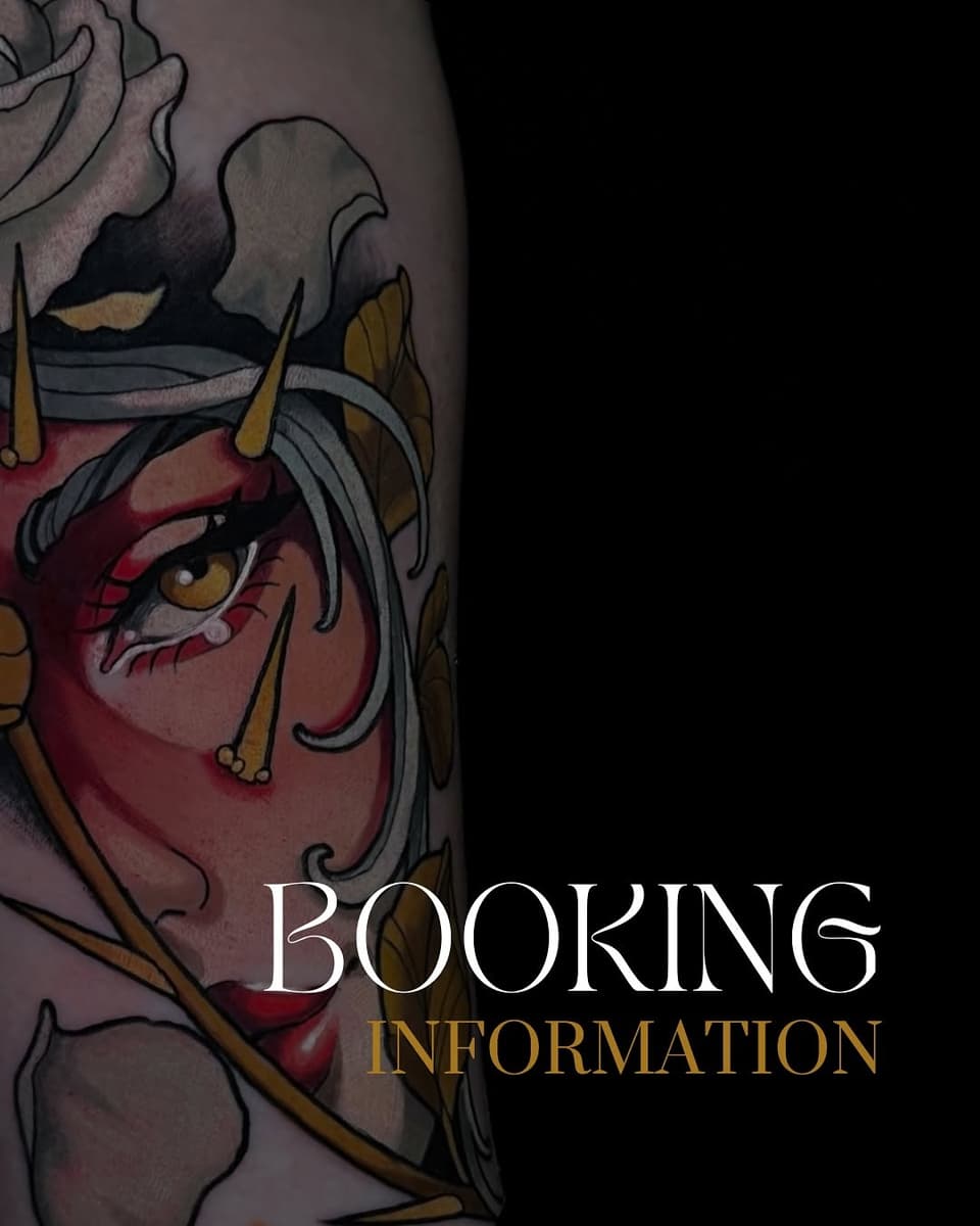 Colorful demon face tattoo on upper arm featuring red skin, golden horns, gray hair, and intricate facial details in red, gold, black, and purple tones.