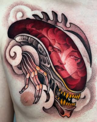 Chest tattoo featuring a red human heart with a jellyfish, spiral shell, and orange-spotted tentacles in muted earth tones and black outlines.