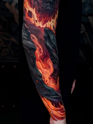 Full-length arm sleeve tattoo featuring flowing lava and molten rock in orange, red, and yellow against dark charcoal backgrounds.