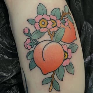 Colorful tattoo on leg featuring a large orange balloon surrounded by pink flowers with yellow centers and green leaves on a brown stem.
