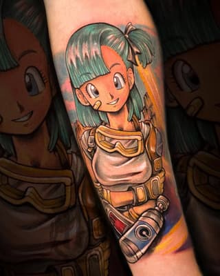 Colorful arm tattoo featuring a smiling anime girl with green hair in an orange and yellow outfit with utility belt and goggles.