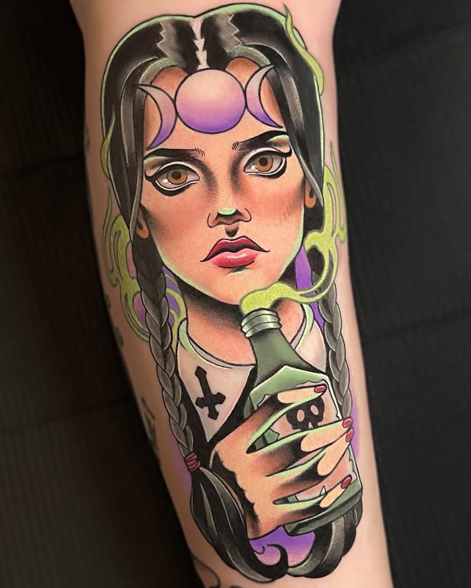 Colorful leg tattoo featuring a woman with braided hair, moon phase forehead design, holding a potion bottle, with purple and green accents.