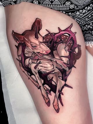 Anatomical demon or creature tattoo in burgundy and pink tones on thigh, featuring horns, detailed musculature, and spiky protrusions.
