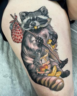Colorful tattoo on thigh of a raccoon holding a bag of strawberries and wearing clothing with fruit designs, featuring red, yellow, and grey tones.