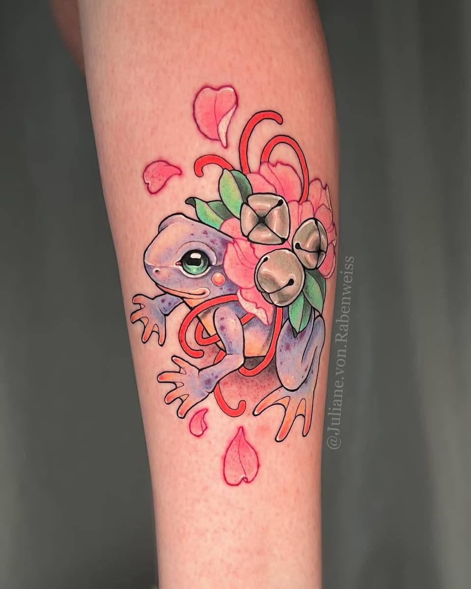 Colorful tattoo on a calf featuring a purple axolotl holding red tentacles and pink flowers with green leaves and falling petals.