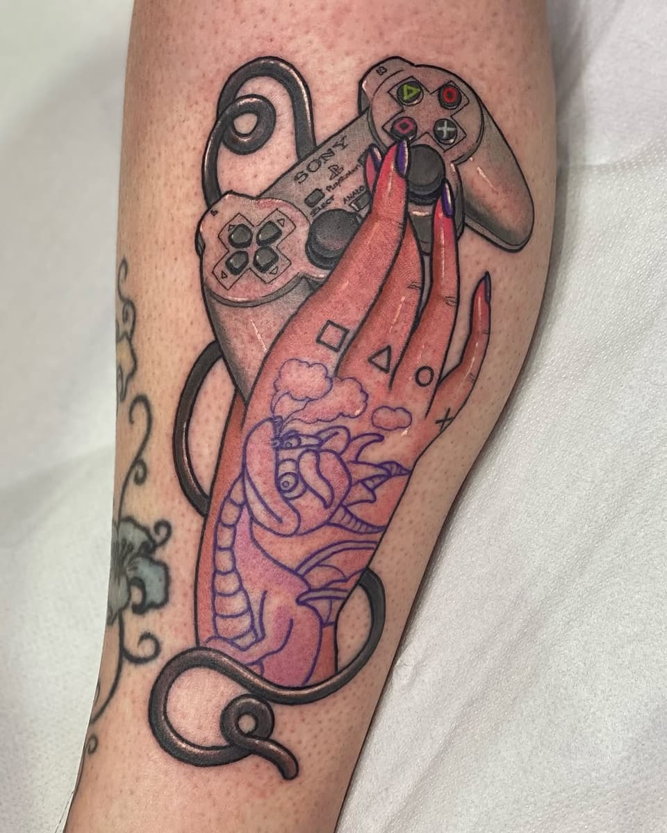 Colorful tattoo on a calf featuring an Xbox controller with a red octopus tentacle, clouds, and geometric shapes intertwined together.