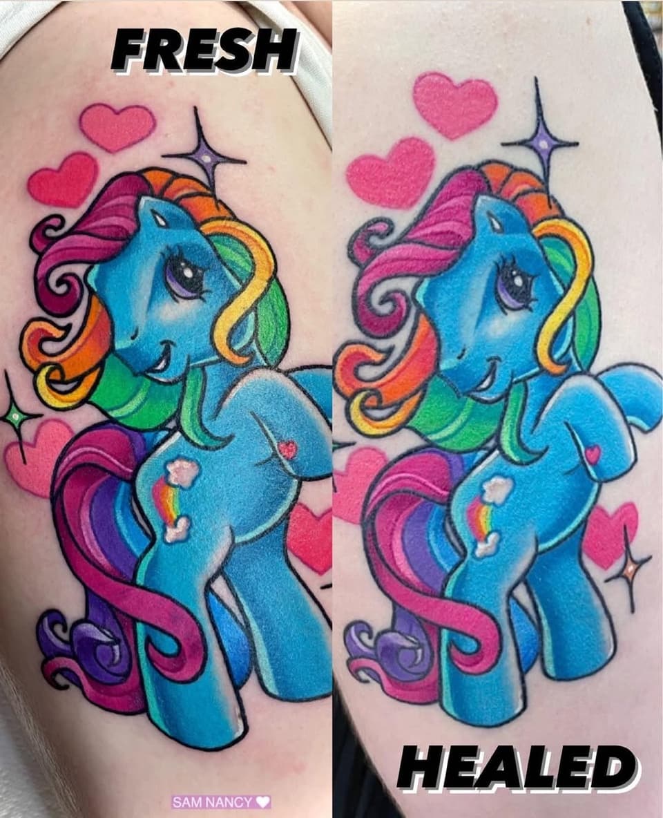 Colorful blue pony tattoo with rainbow mane, pink hearts, and decorative swirls on upper arm, shown fresh and healed side-by-side.