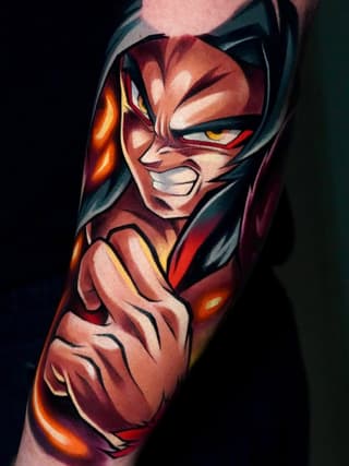 Colorful superhero character tattoo on the upper arm featuring red, orange, and yellow tones with dynamic facial expression and muscular shoulders.