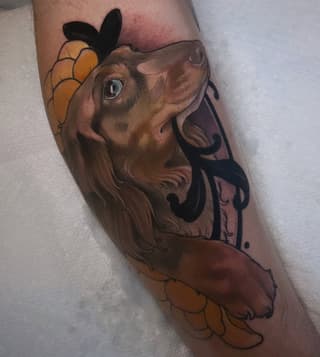 Brown dog head with black ears and gold flower details on the calf, featuring expressive eyes and decorative line work.