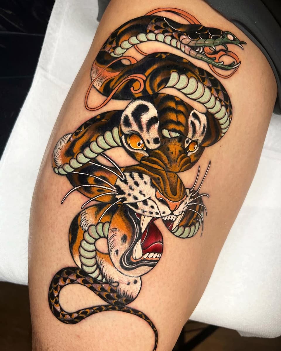 Tiger and snake intertwined vertically on the thigh in orange, black, cream, and red with detailed scales and facial features.