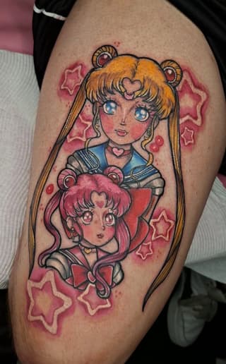 Colorful leg tattoo featuring two anime-style girls with blonde and pink hair surrounded by pink stars and heart symbols.