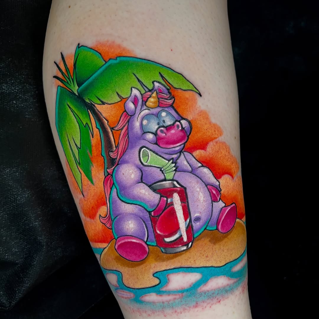 Purple cartoon hippo character holding a drink under tropical foliage with orange sunset background on calf.