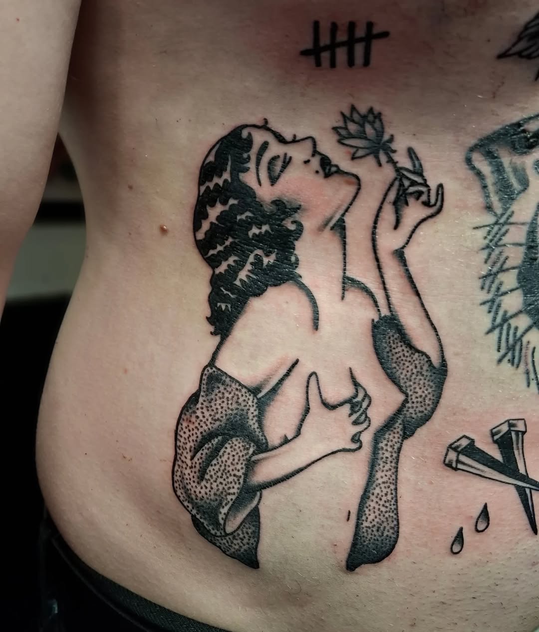 Topless figure with flowing hair and butterfly, detailed stippled shading on torso and arms, chest placement.
