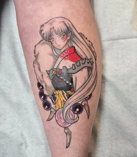 Inuyasha character tattoo on calf featuring long-haired woman in red and black outfit with purple spiritual orbs and flowing hair ribbons.