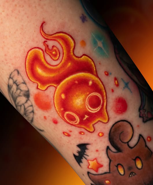 Aries the Fire elemental spirit from Avatar: The Last Airbender on an arm, rendered in vibrant reds, oranges, and yellows with surrounding magical elements and stars.